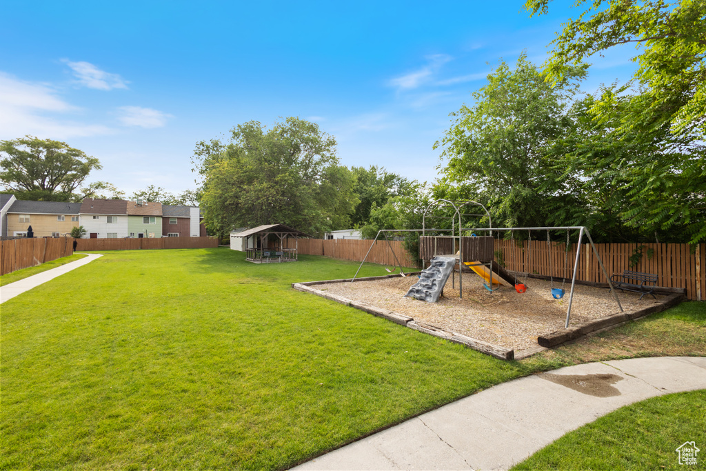 Fenced backyard with a playground
