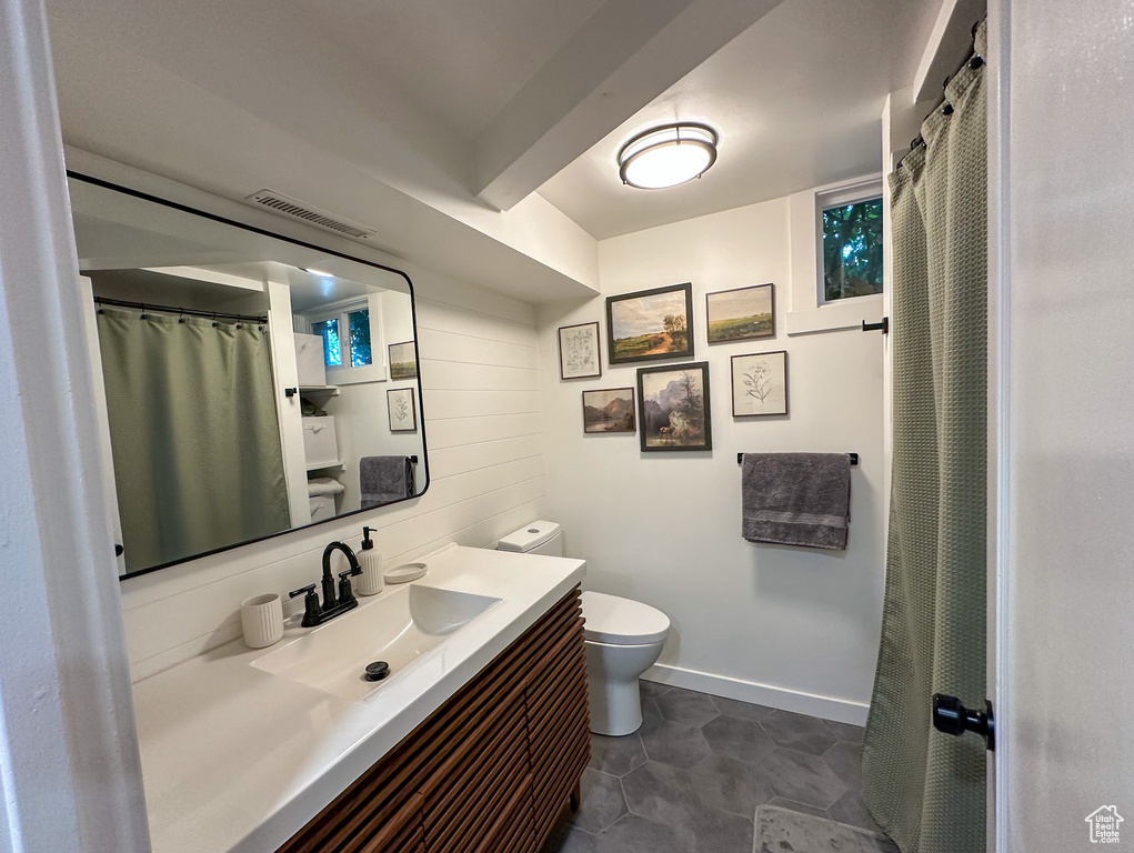 Full bath featuring toilet and vanity