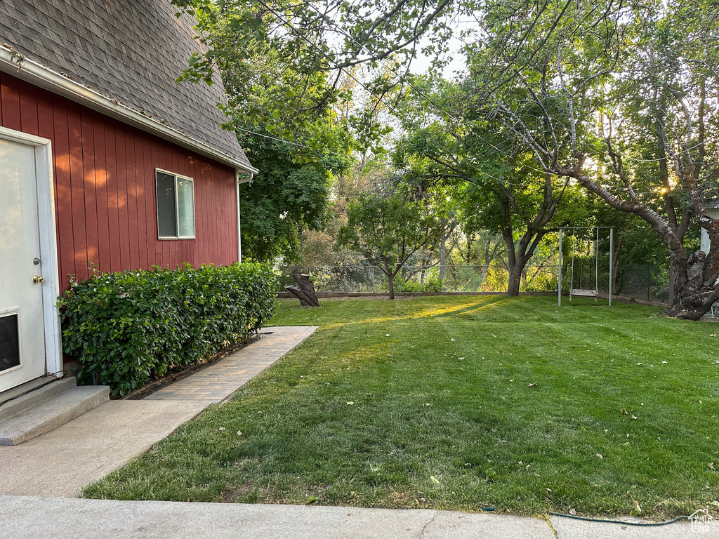 View of grassy yard with entry steps