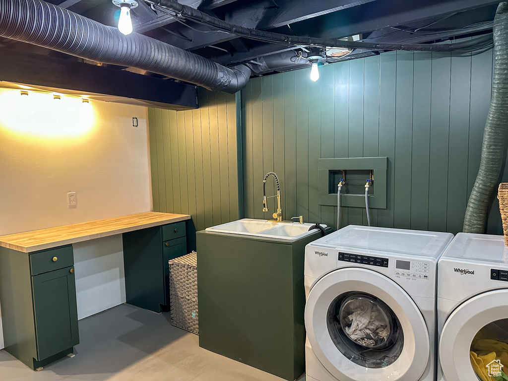 Laundry room with independent washer and dryer and wooden walls