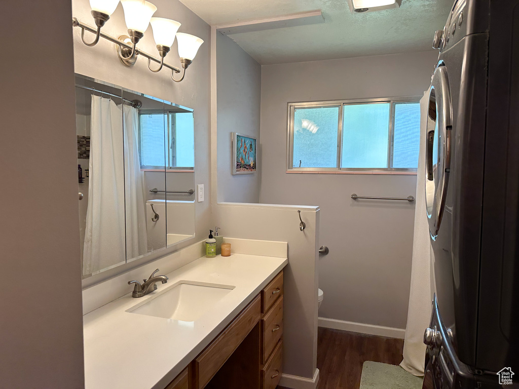 Full bath featuring wood finished floors, vanity, and a shower with curtain