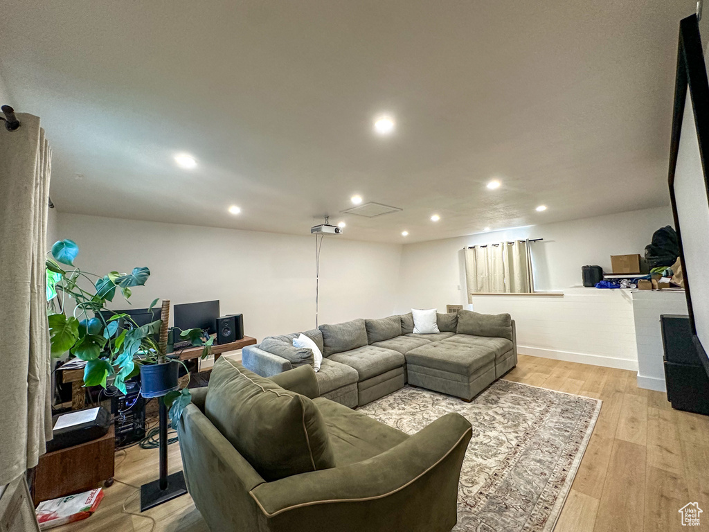 Living room with recessed lighting and light wood-style floors