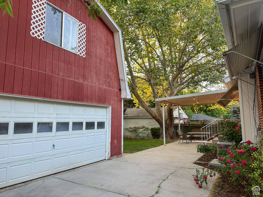 Garage featuring concrete driveway