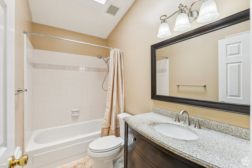 Full bathroom with shower / bath combo with shower curtain and vanity
