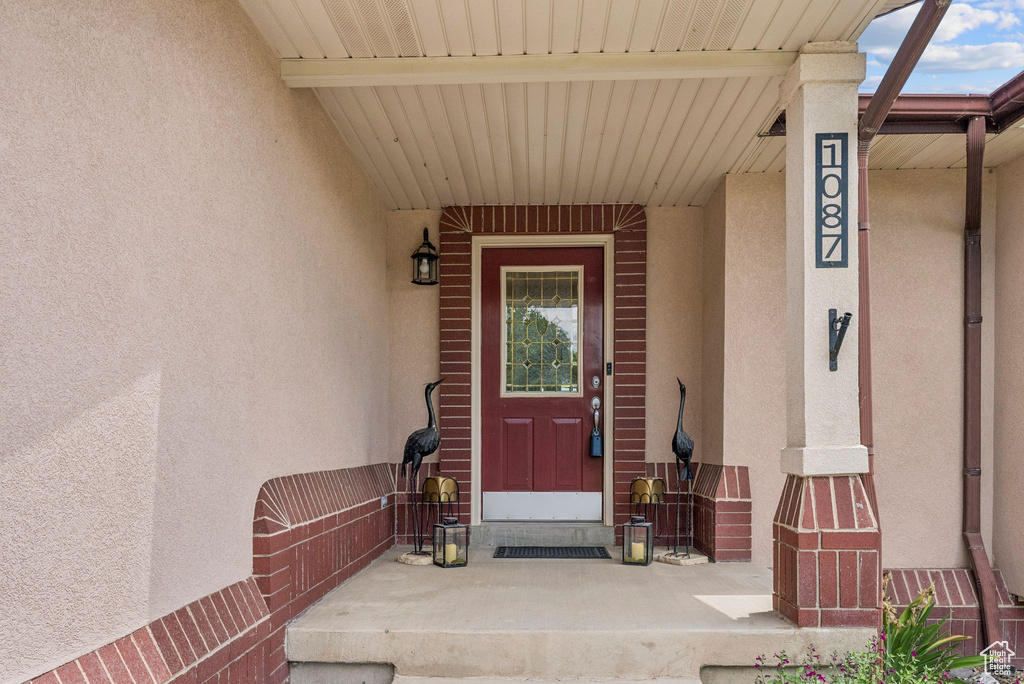 Entrance to property with stucco siding