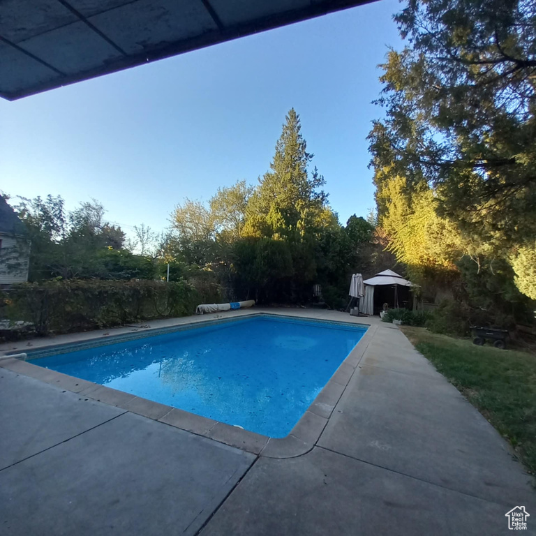 View of pool with a patio and a gazebo