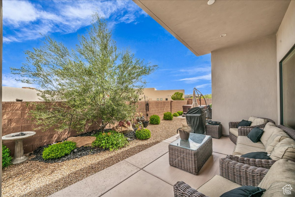 Fenced backyard with an outdoor hangout area, a patio area, and grilling area
