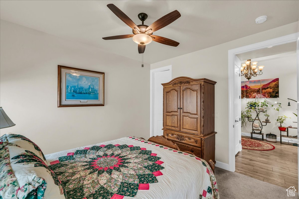 Bedroom featuring a chandelier and a ceiling fan