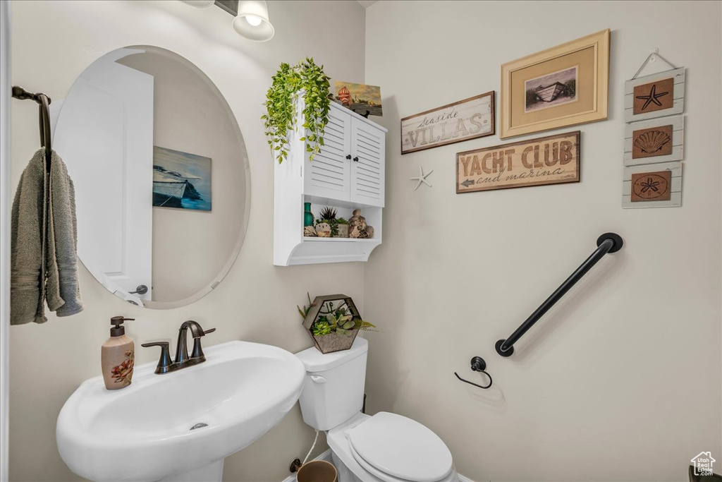 Half bath featuring a sink and toilet