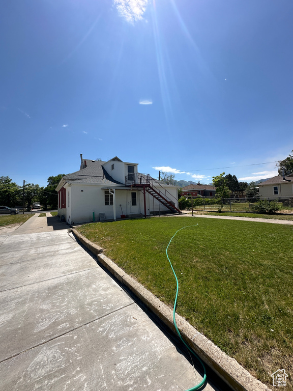 View of side of home featuring stairs