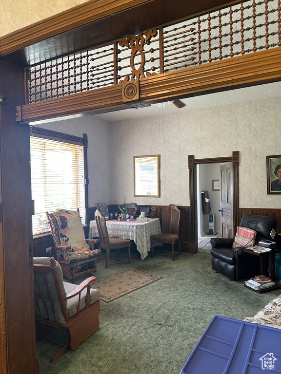 Carpeted living room featuring a ceiling fan