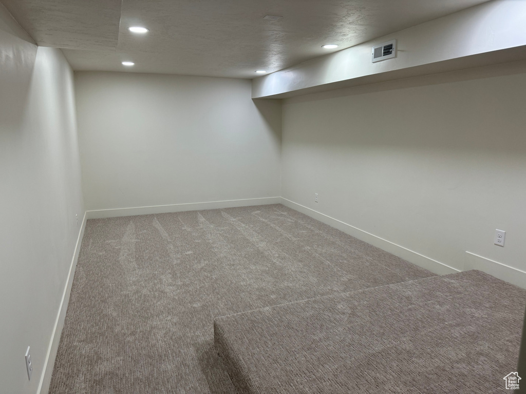 Finished below grade area with recessed lighting and carpet floors