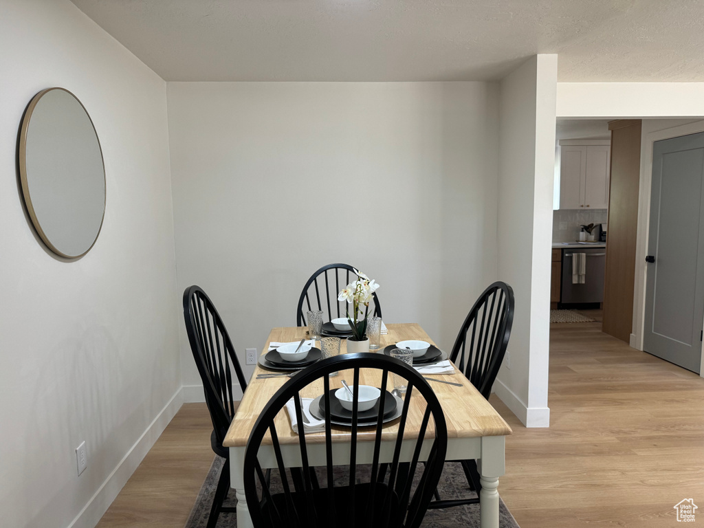 Dining space with baseboards and light wood-type flooring