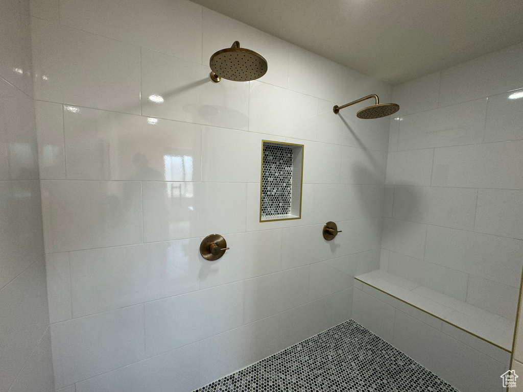 Bathroom featuring tiled shower and tile patterned flooring