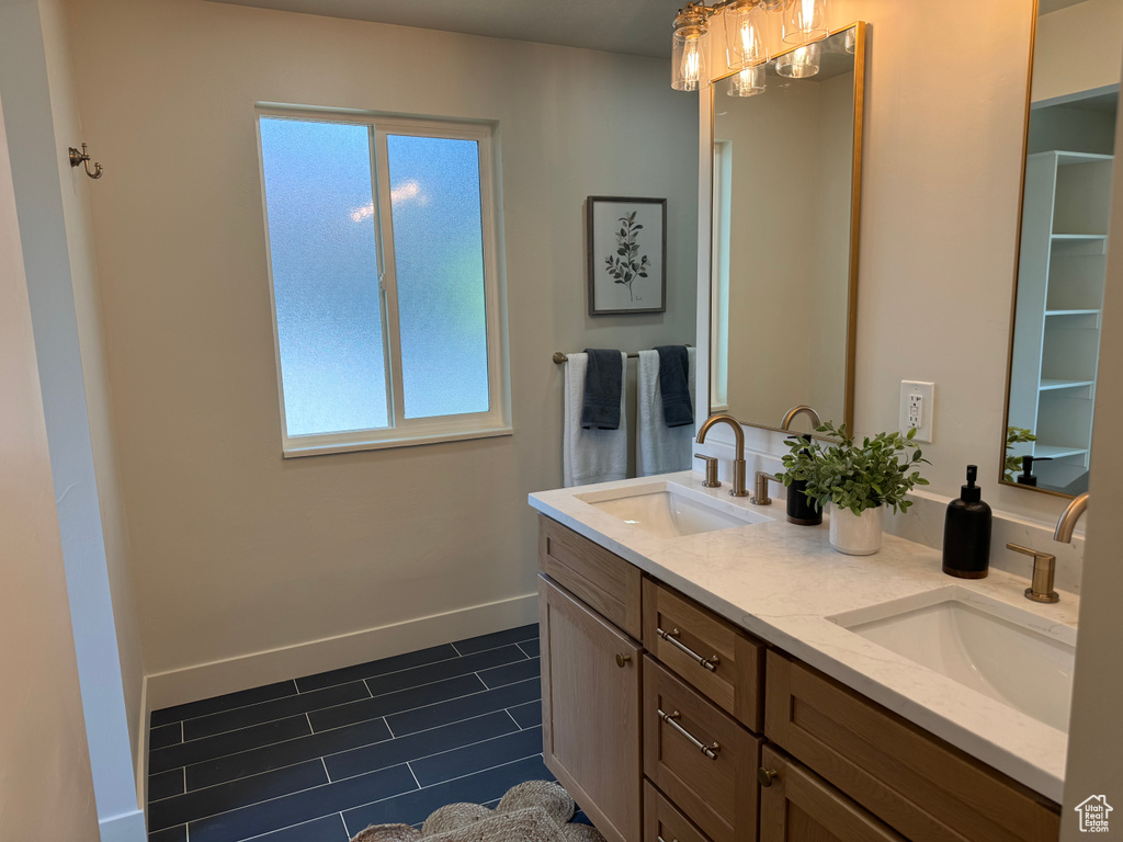 Full bath with double vanity and tile patterned floors