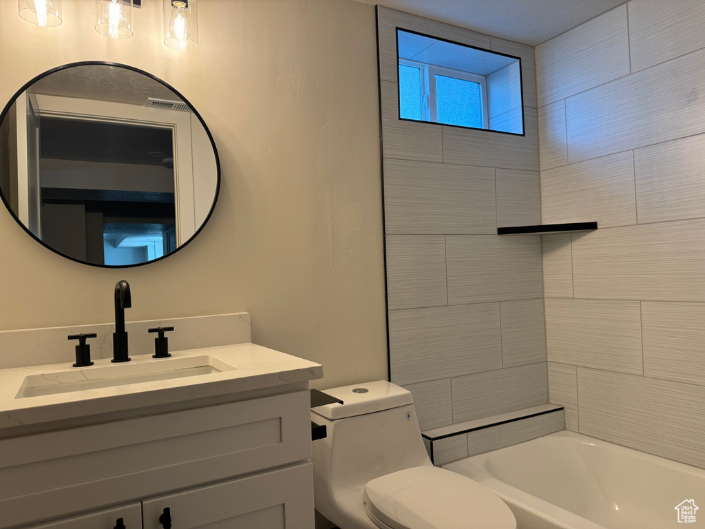 Bathroom with vanity and shower / bath combination