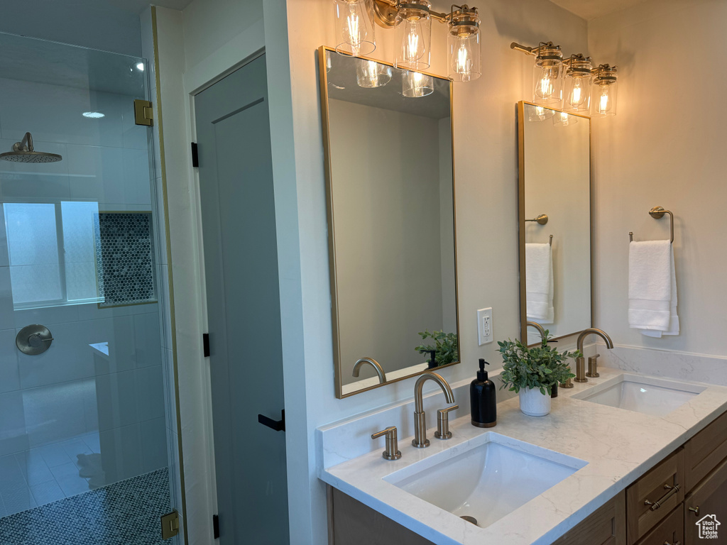Full bath featuring a stall shower and double vanity