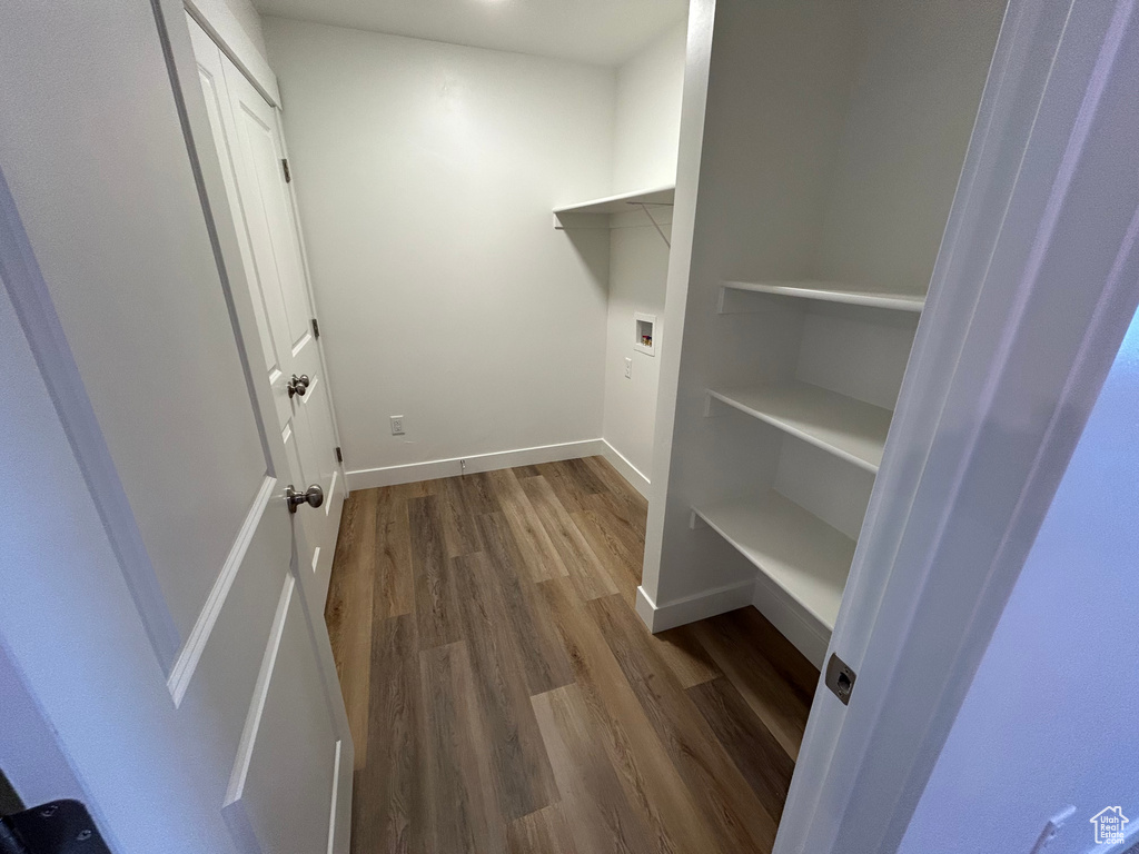 Laundry room with wood finished floors and hookup for a washing machine