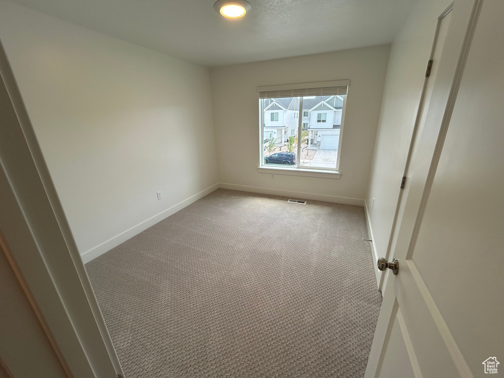 Unfurnished room featuring light carpet and recessed lighting