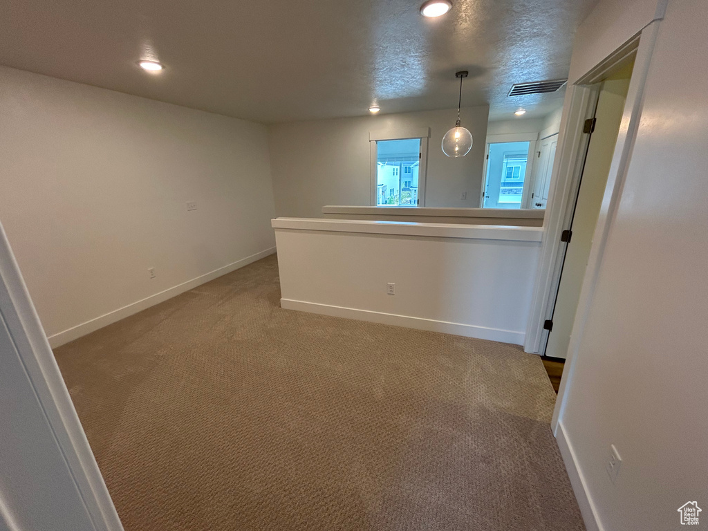 Unfurnished room with light carpet and recessed lighting