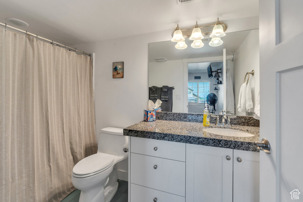 Full bath featuring vanity, a chandelier, and a shower with curtain