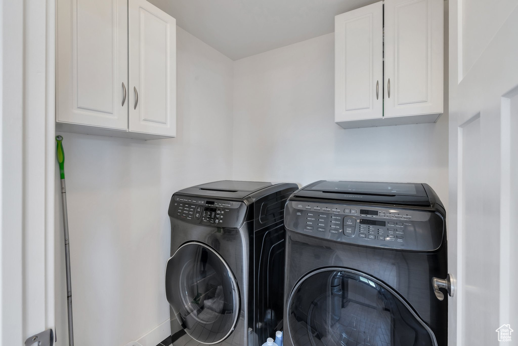 Laundry room with washing machine and dryer and cabinet space