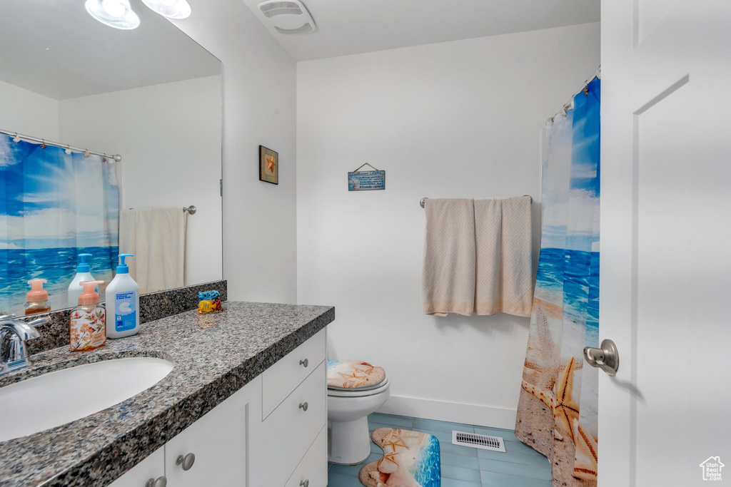 Full bath with vanity, tile patterned flooring, and a shower with shower curtain