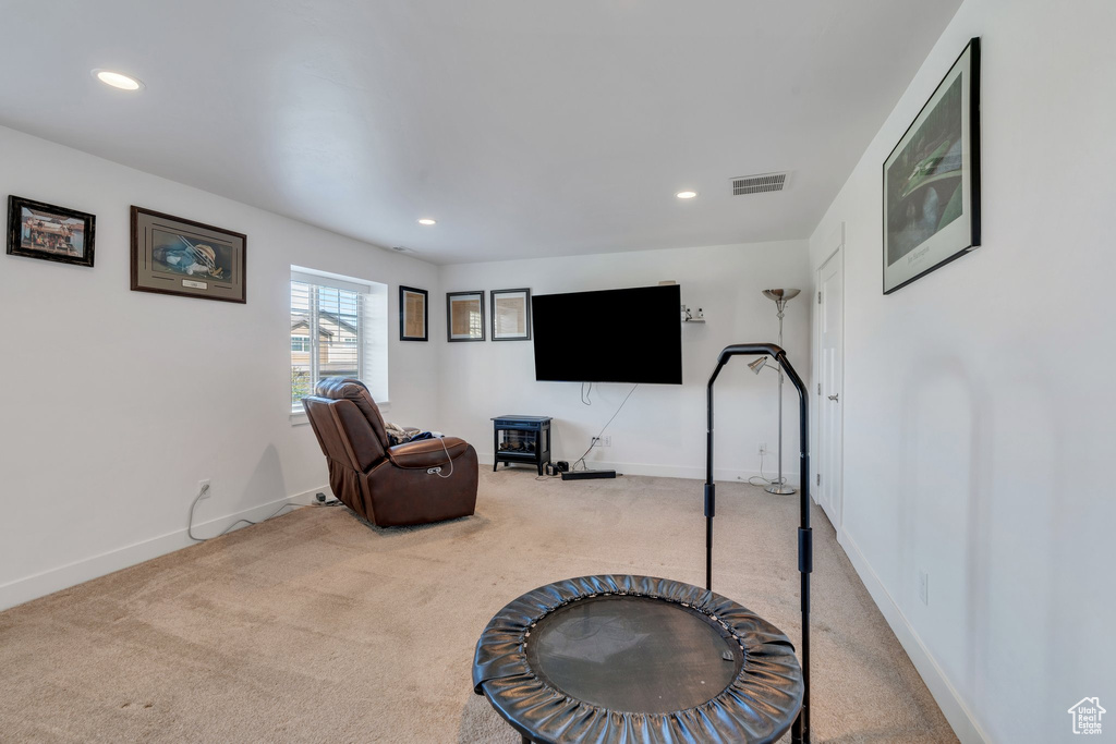 Workout area with carpet flooring and recessed lighting