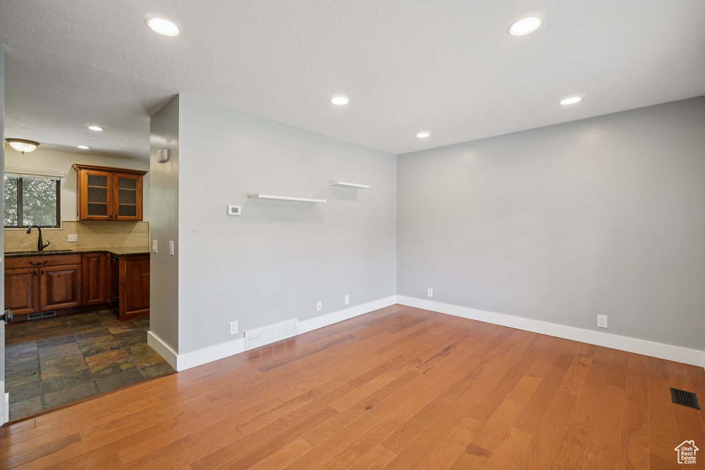 Empty room with recessed lighting and dark wood-type flooring