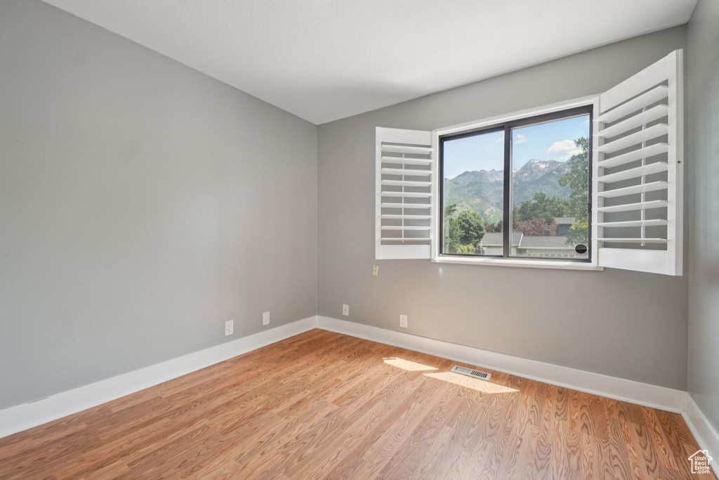 Empty room featuring wood finished floors and baseboards