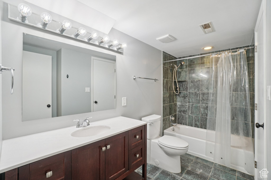 Full bathroom with shower / tub combo and vanity