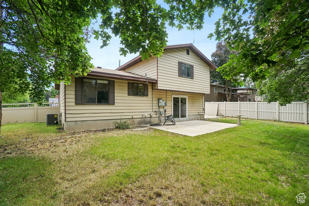 Rear view of house featuring a patio and a fenced backyard