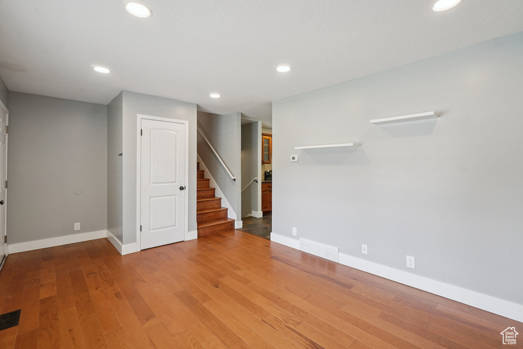 Spare room featuring stairway, recessed lighting, and wood finished floors
