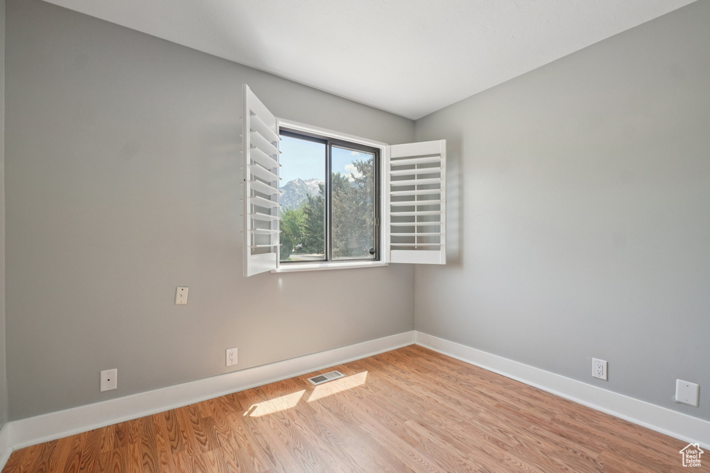 Unfurnished room with baseboards and wood finished floors