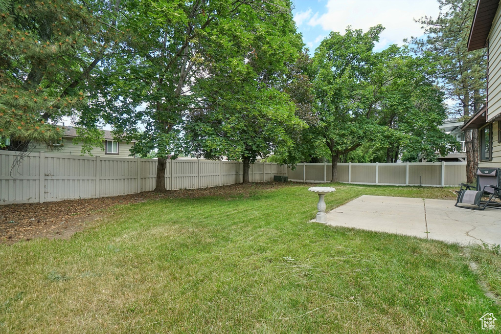 Fenced backyard featuring a patio