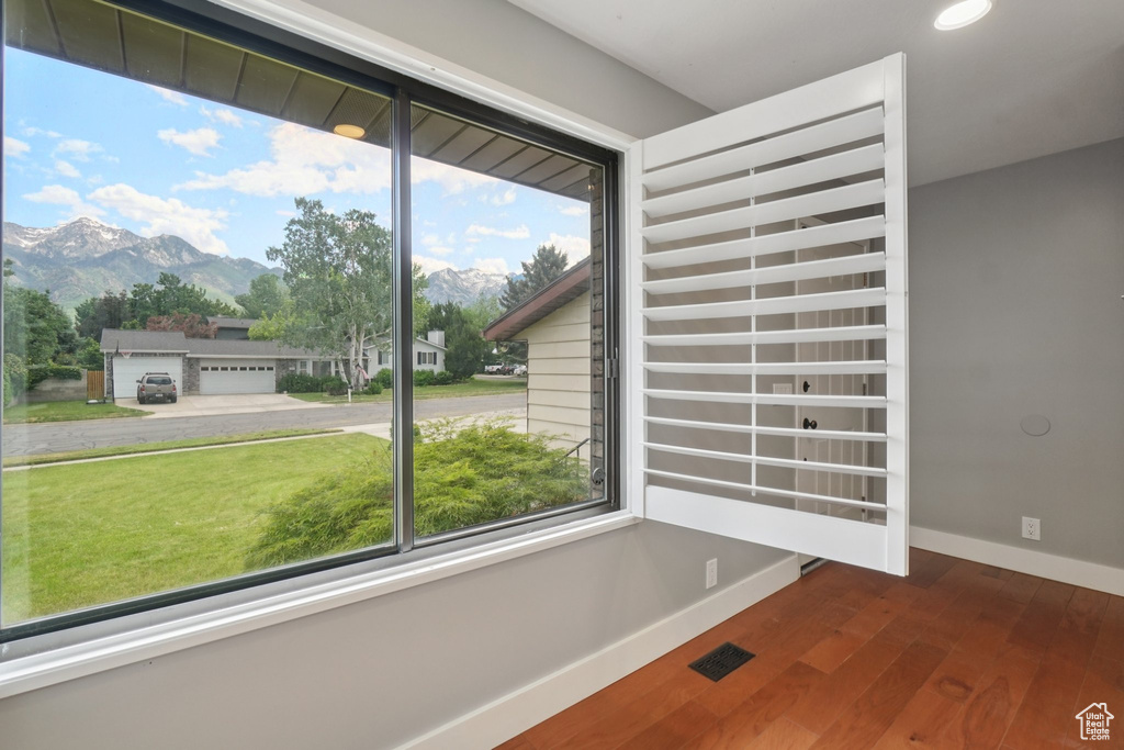 Unfurnished room featuring a mountain view, wood finished floors, and recessed lighting