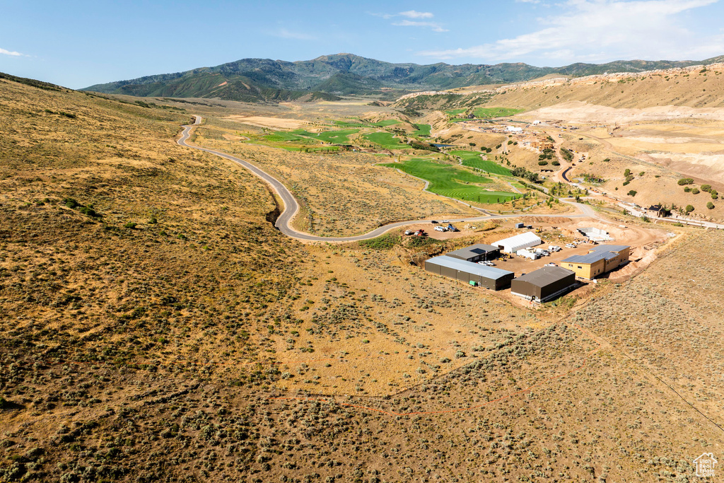 Aerial view of property's location featuring a mountainous background and rural landscape