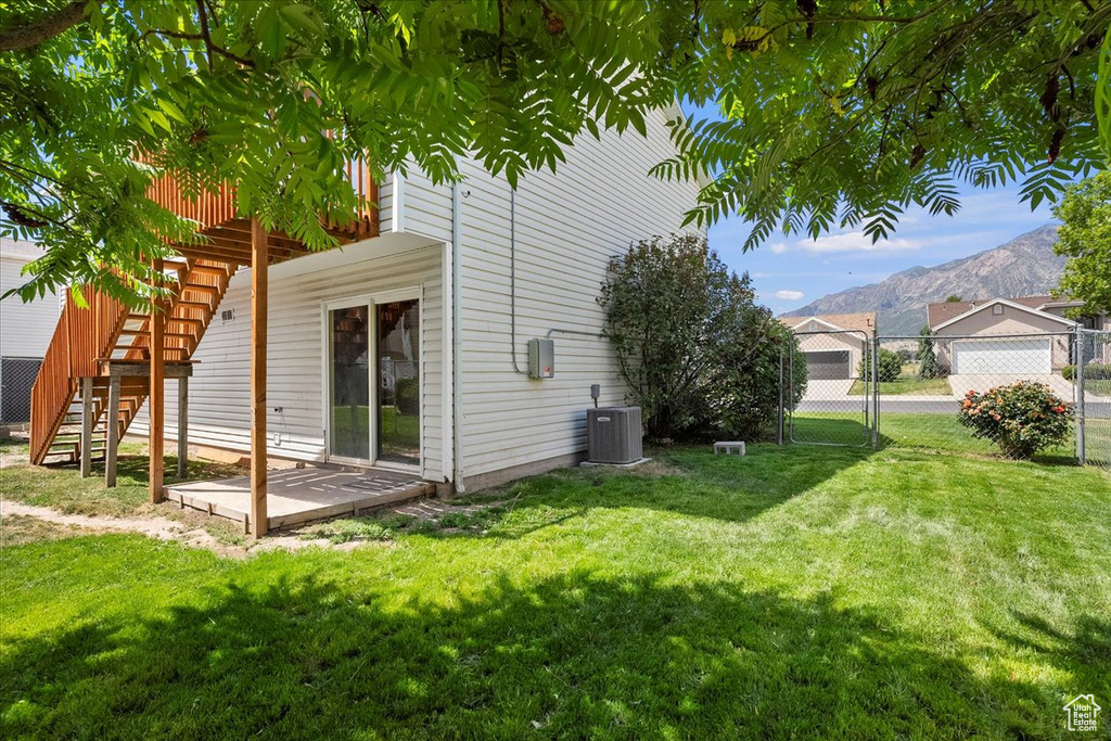 View of home\'s exterior featuring a mountain view, stairway, and a gate