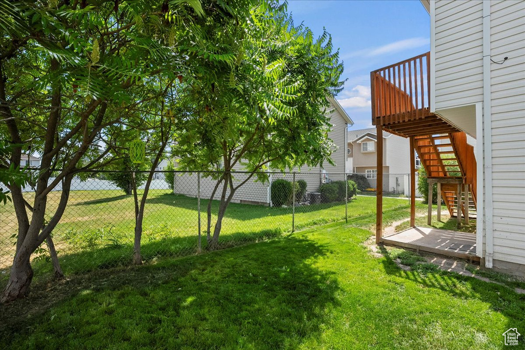 Fenced backyard featuring stairway and a wooden deck
