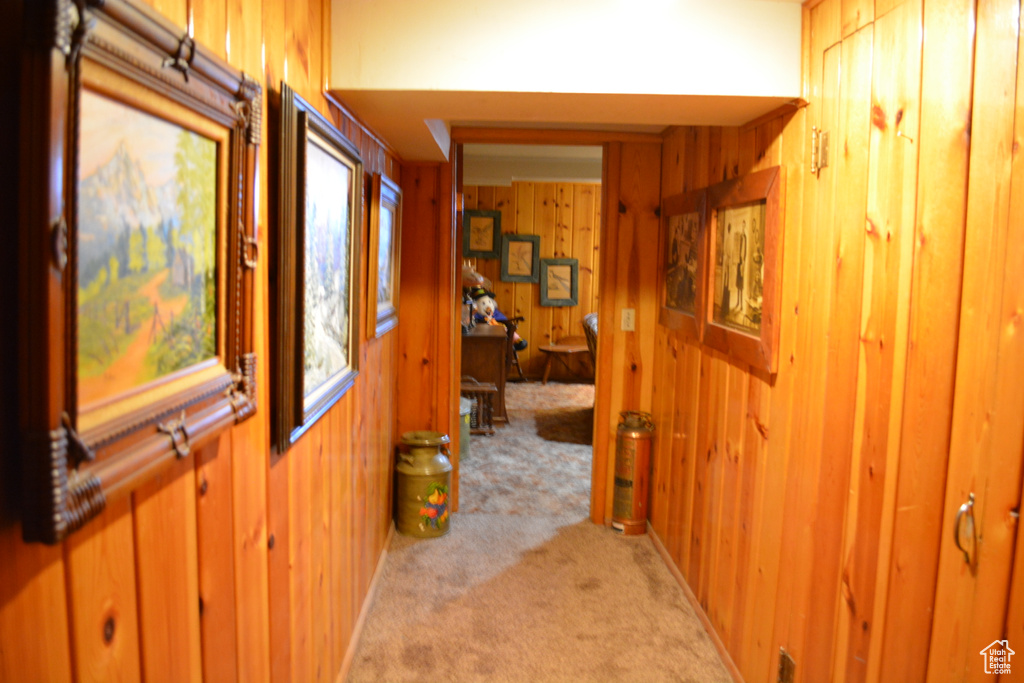 Corridor with light carpet and wooden walls
