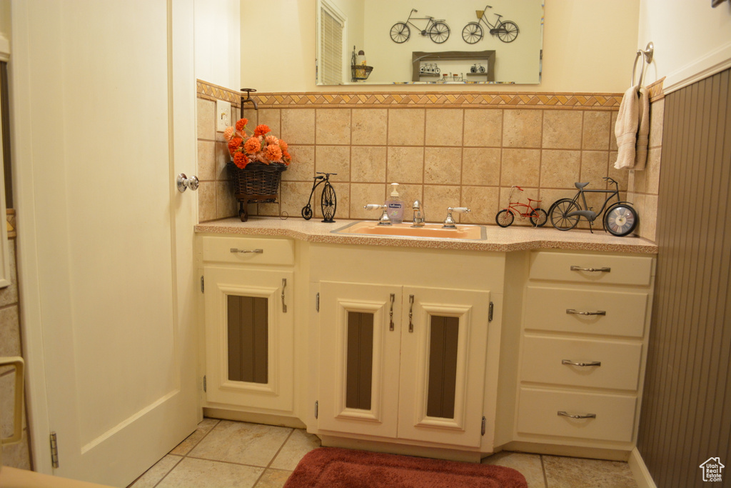 Bathroom with tile patterned floors and vanity