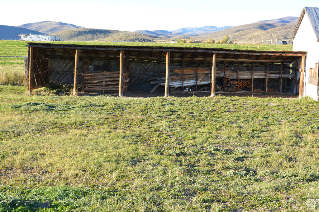 View of pole building with a mountain view