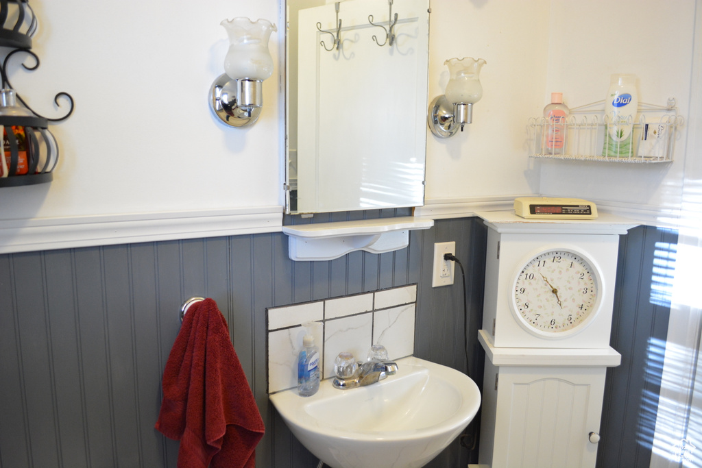 Bathroom featuring a sink and wainscoting