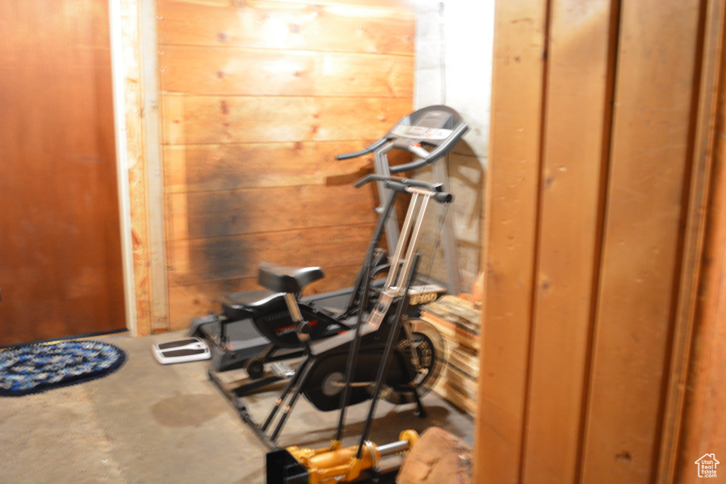 Workout area featuring wood walls
