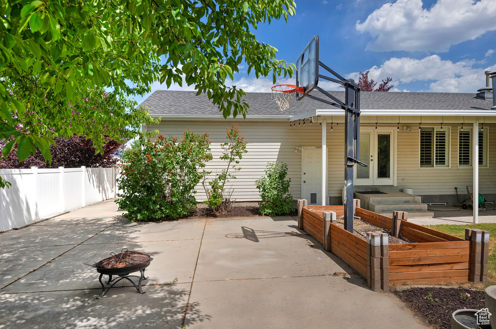 View of patio with french doors and a fire pit