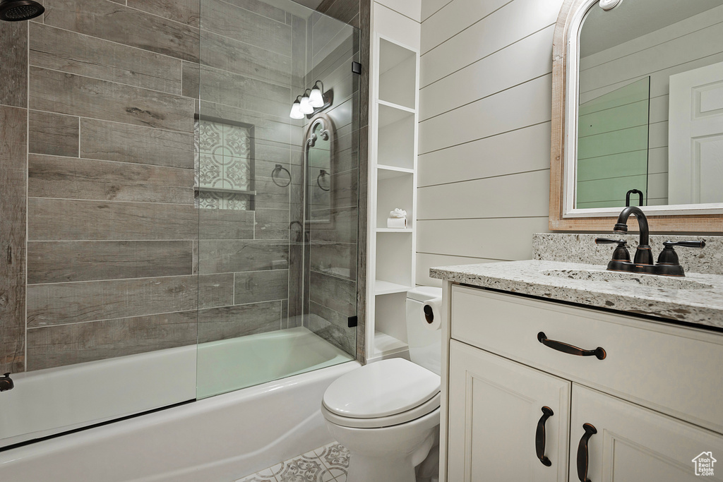 Bathroom with vanity and enclosed tub / shower combo