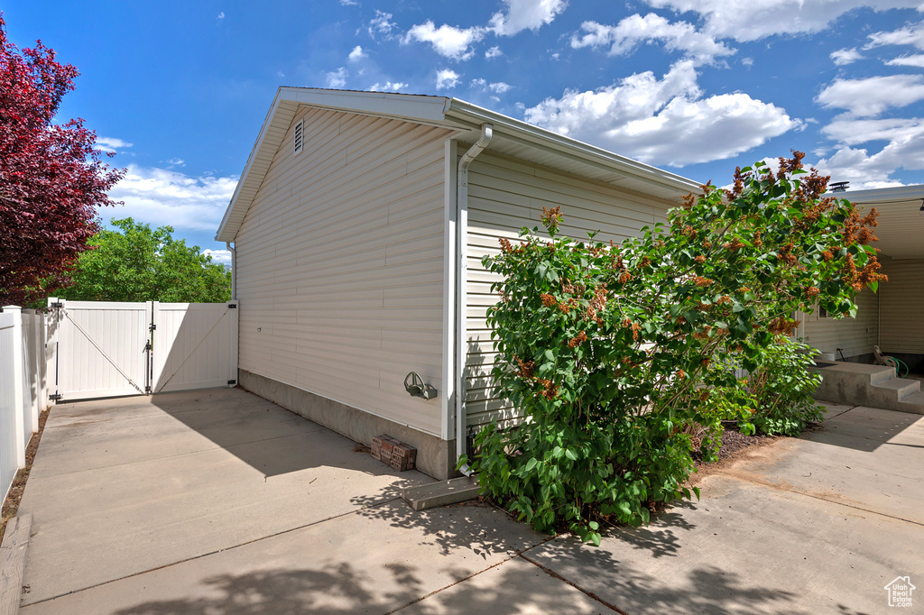 View of side of property with a gate