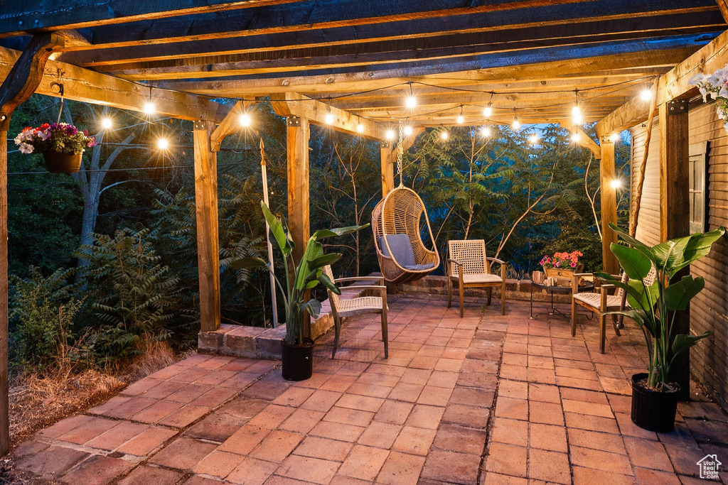 Patio at twilight with a patio area and a pergola