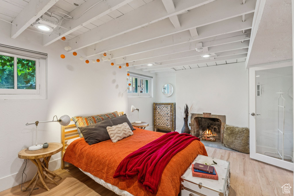Bedroom featuring wood finished floors and beam ceiling