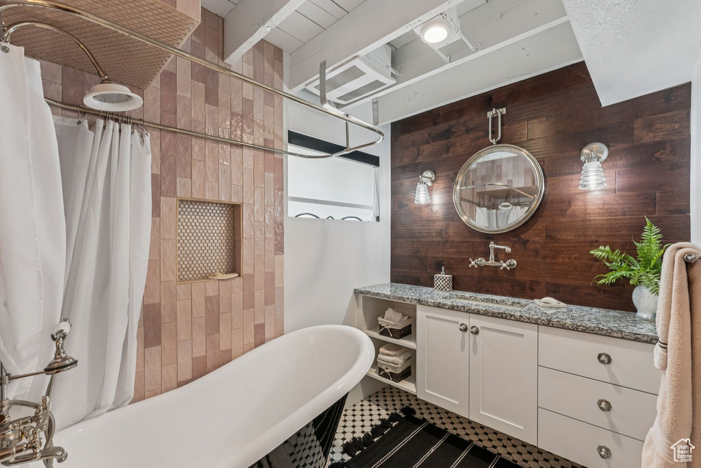 Bathroom with vanity and wooden walls